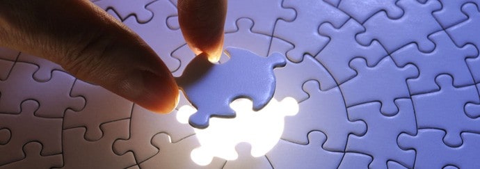 A man inserts the last piece of the puzzle